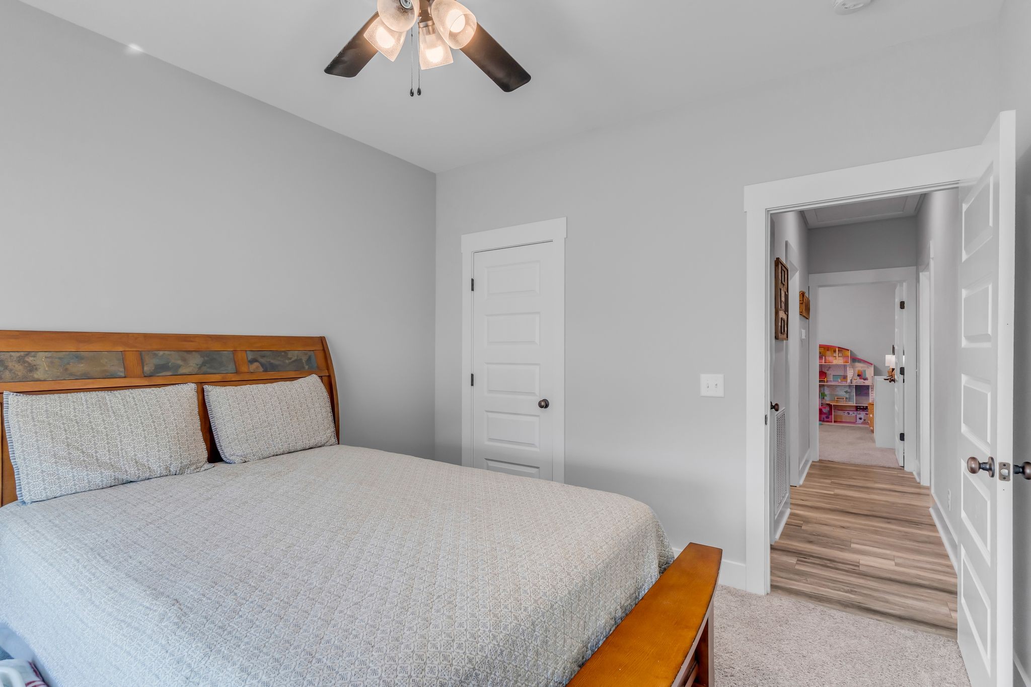195 Julia Ann Court Springfield, TN 37172 - Photo 12 of 28 a bedroom with a bed and a chandelier