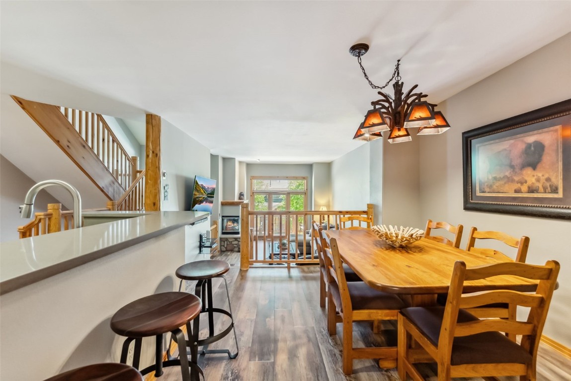 434 Kings Crown Road, Unit 434 Breckenridge, CO 80424 - Photo 18 of 50 a dining room with furniture a chandelier and wooden floor