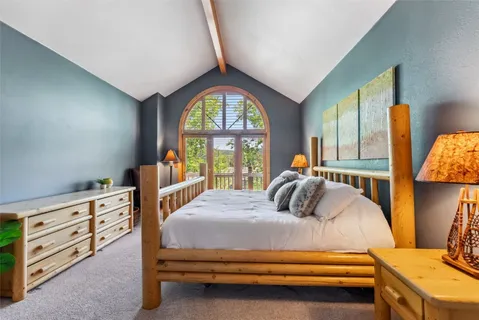 a bedroom with furniture and a large window