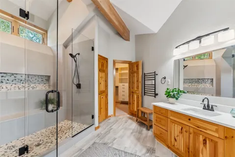 a spacious bathroom with a double vanity sink shower and a mirror