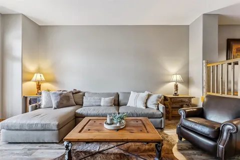 a living room with furniture and a lamp