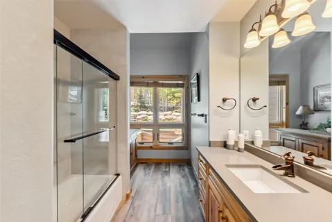 a bathroom with a sink mirror and vanity