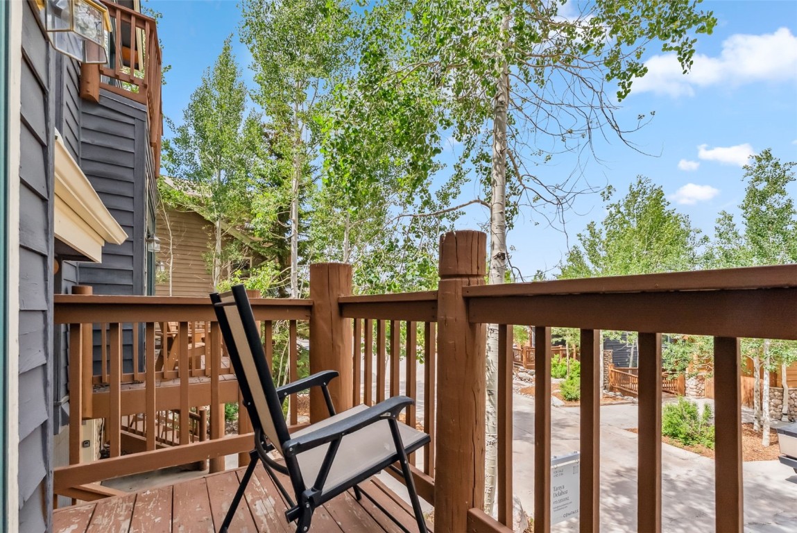434 Kings Crown Road, Unit 434 Breckenridge, CO 80424 - Photo 45 of 50 a view of a balcony with wooden floor and outdoor seating