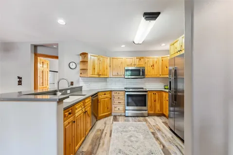 a kitchen with stainless steel appliances granite countertop a sink and cabinets