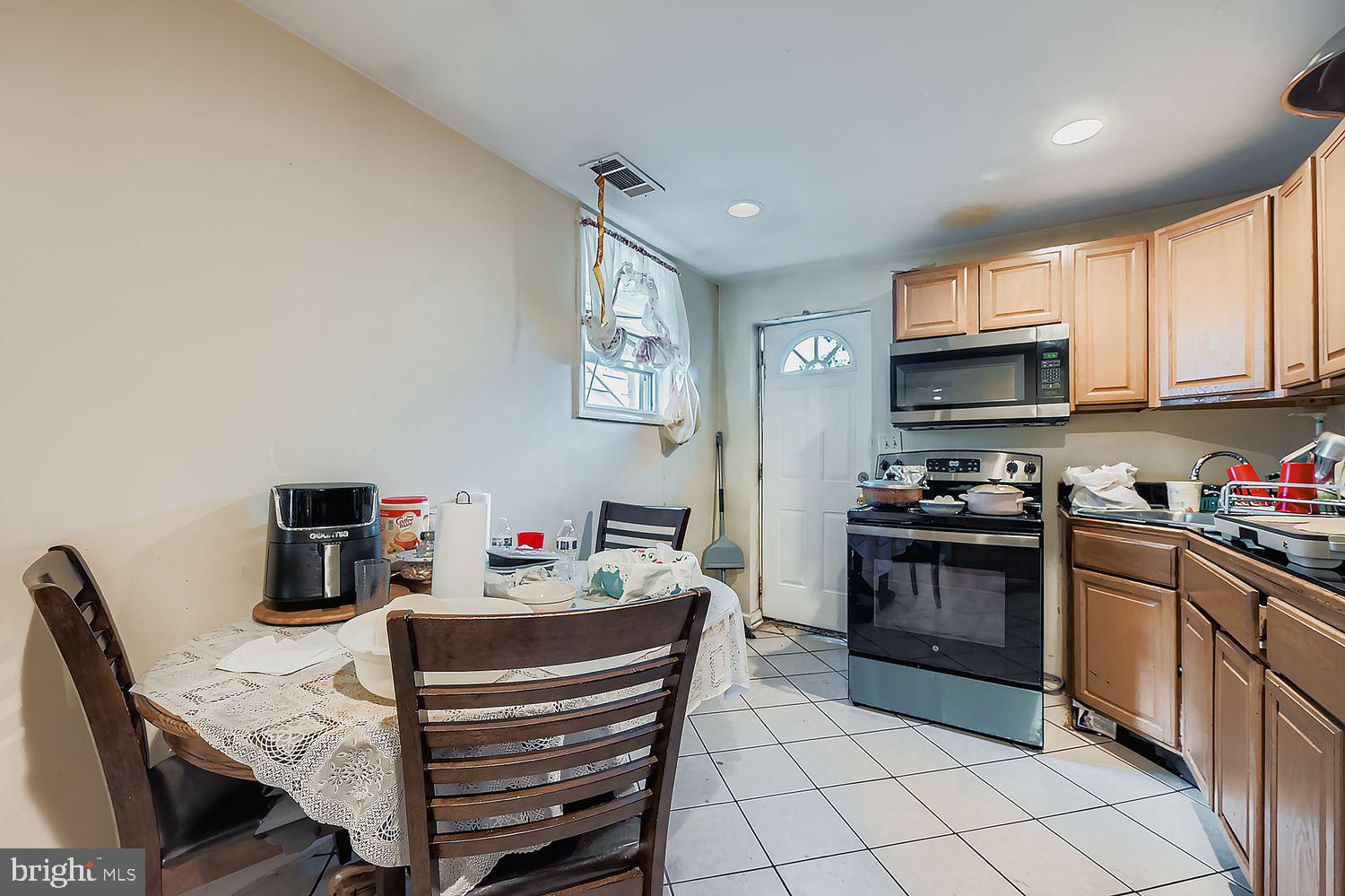 329 South Gilmor Street Baltimore, MD 21223 - Photo 11 of 28 a kitchen with a stove a sink and a refrigerator