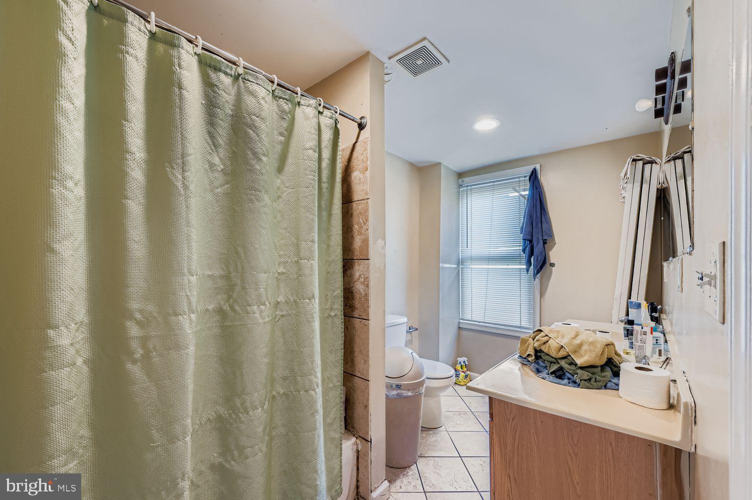 329 South Gilmor Street Baltimore, MD 21223 - Photo 15 of 28 a bathroom with a sink a mirror and a shower