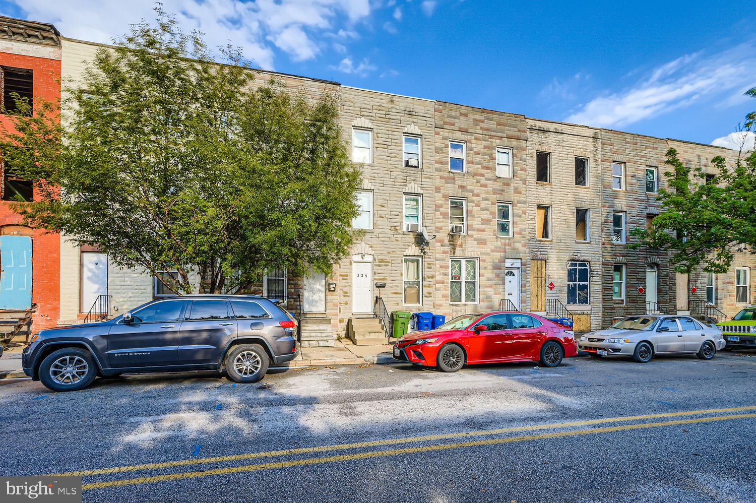 329 South Gilmor Street Baltimore, MD 21223 - Photo 2 of 28 a view of cars parked in front of a building