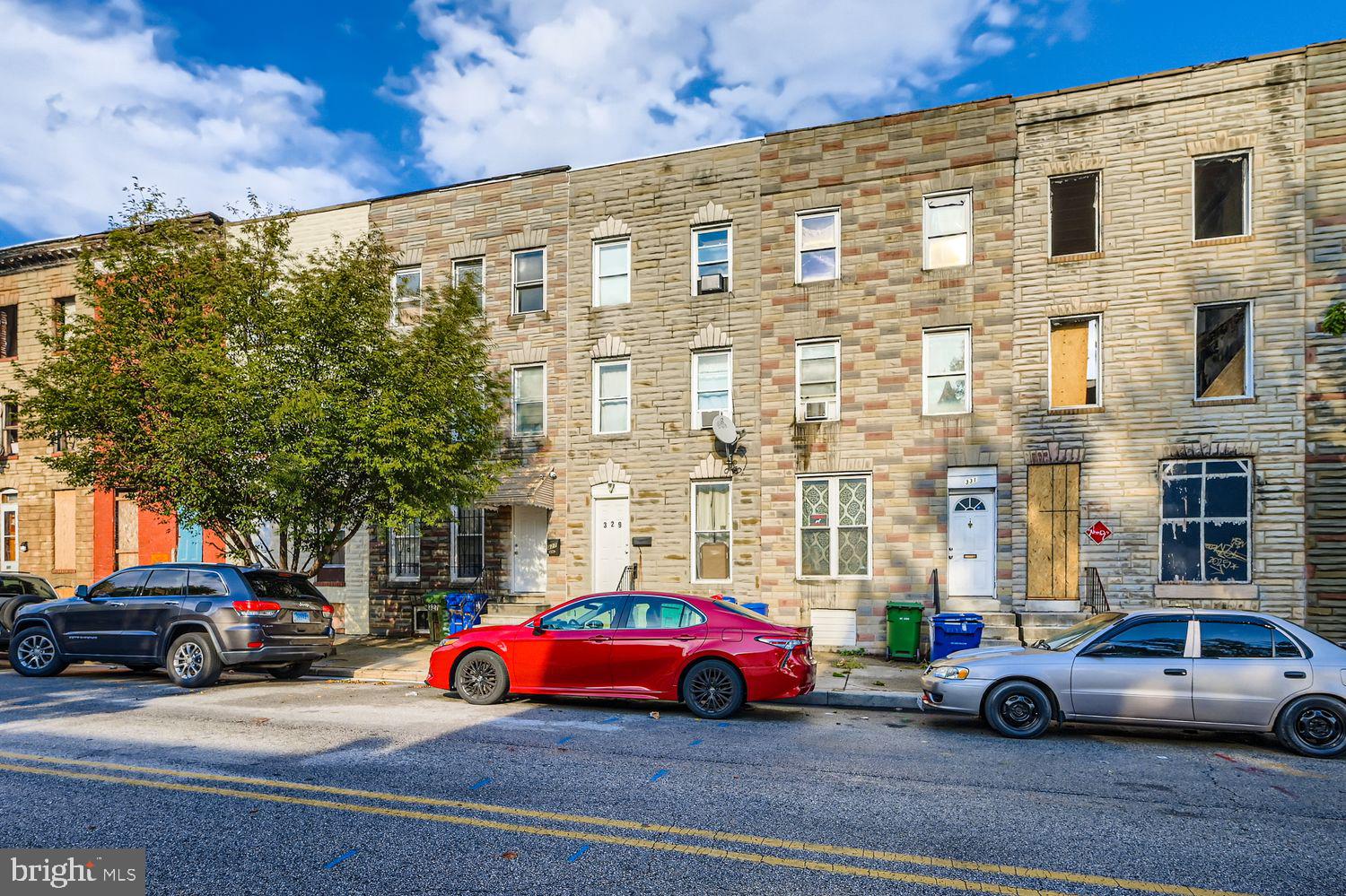 329 South Gilmor Street Baltimore, MD 21223 - Photo 3 of 28 a car parked in front of a building