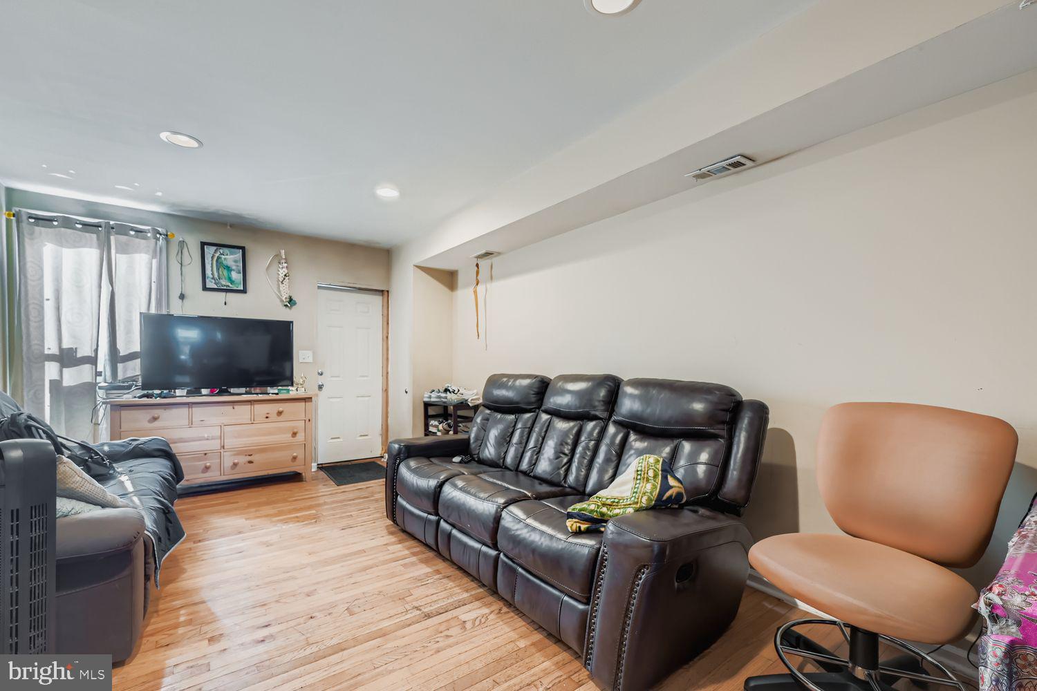 329 South Gilmor Street Baltimore, MD 21223 - Photo 5 of 28 a living room with furniture and a flat screen tv
