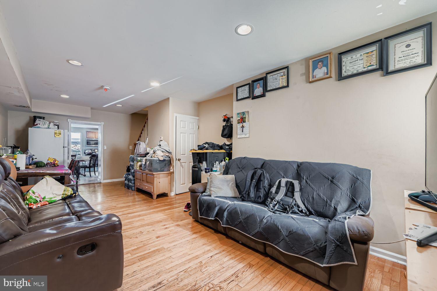 329 South Gilmor Street Baltimore, MD 21223 - Photo 6 of 28 a living room with furniture or couch and a wooden floor
