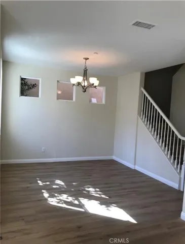 a view of wooden floor and staircase in a room