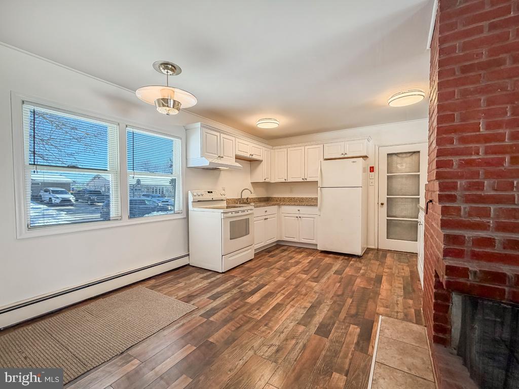 19 Butterfly Lane Levittown, PA 19054 - Photo 11 of 32 a kitchen with cabinets and wooden floor