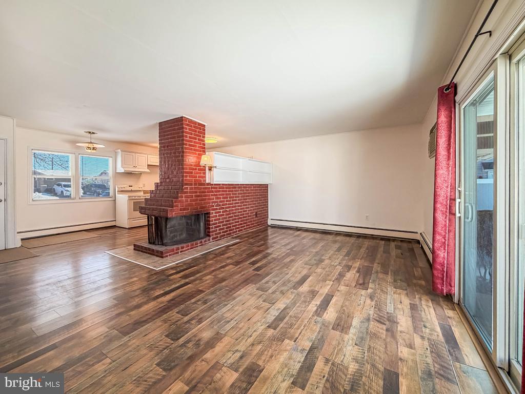 19 Butterfly Lane Levittown, PA 19054 - Photo 12 of 32 a view of empty room with wooden floor and fan
