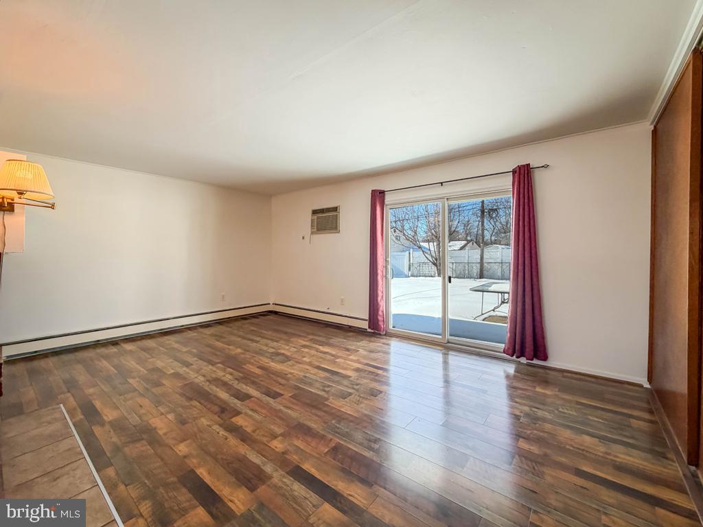 19 Butterfly Lane Levittown, PA 19054 - Photo 13 of 32 a view of an empty room with wooden floor and a window