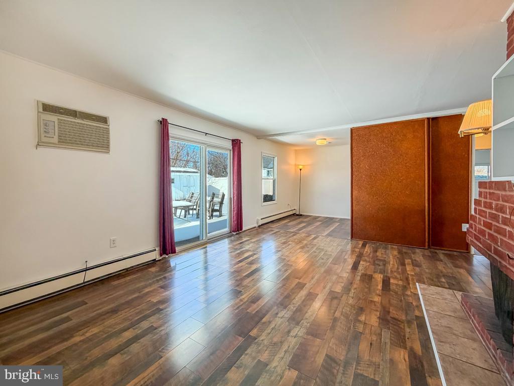 19 Butterfly Lane Levittown, PA 19054 - Photo 16 of 32 a view of an empty room with wooden floor and a window
