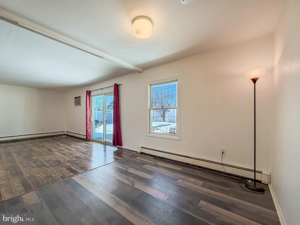 19 Butterfly Lane Levittown, PA 19054 - Photo 17 of 32 an empty room with wooden floor and windows