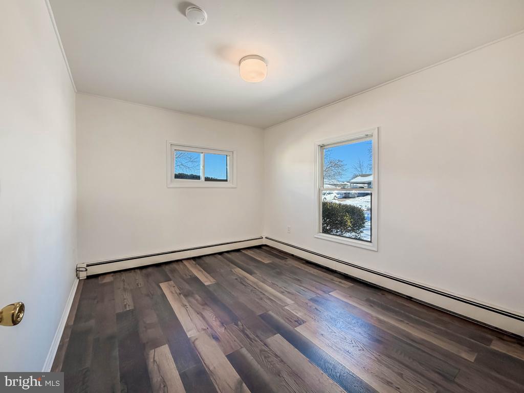 19 Butterfly Lane Levittown, PA 19054 - Photo 20 of 32 an empty room with wooden floor and windows