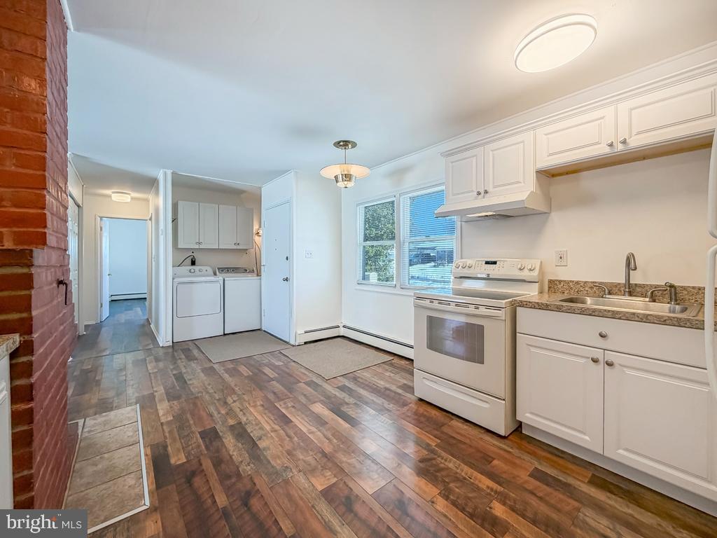 19 Butterfly Lane Levittown, PA 19054 - Photo 6 of 32 a kitchen with a stove a sink and a refrigerator