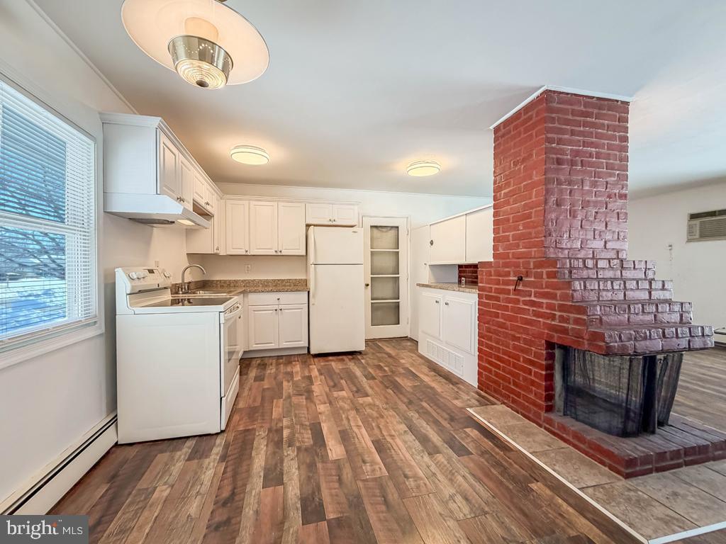 19 Butterfly Lane Levittown, PA 19054 - Photo 10 of 32 a kitchen with cabinets and wooden floor