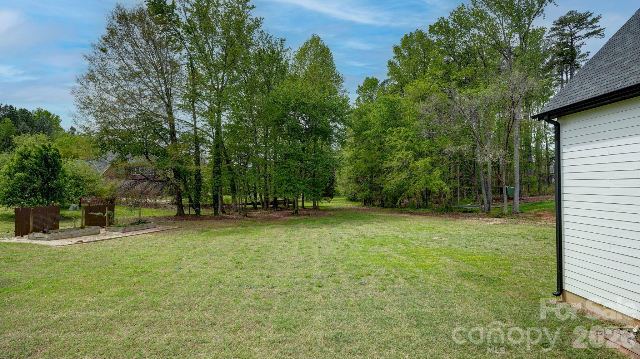 1775 Enochville Road Kannapolis, NC 28081 - Photo 23 of 41 a backyard of a house with plants and large tree