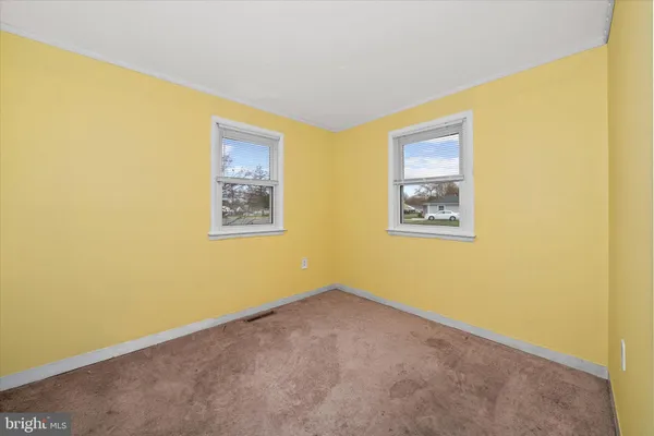 a view of an empty room with windows