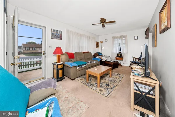 a living room with furniture a rug and a window