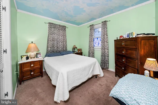 a bedroom with a bed and dresser