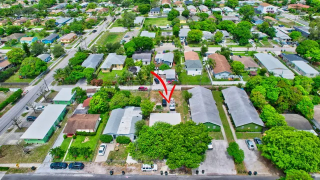 an aerial view of multiple houses with yard