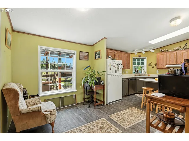 a living room with furniture a flat screen tv and a window