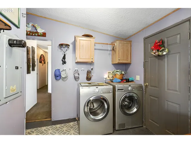 a utility room with fridge dryer and washer