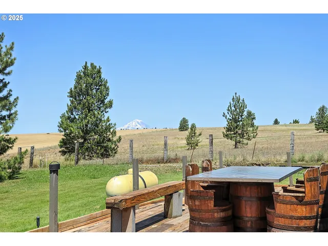 a view of a backyard with sitting area