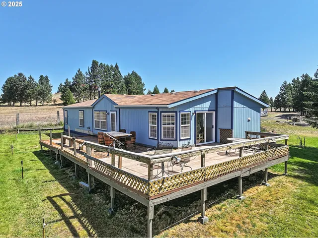 a roof deck with a table and a barbeque