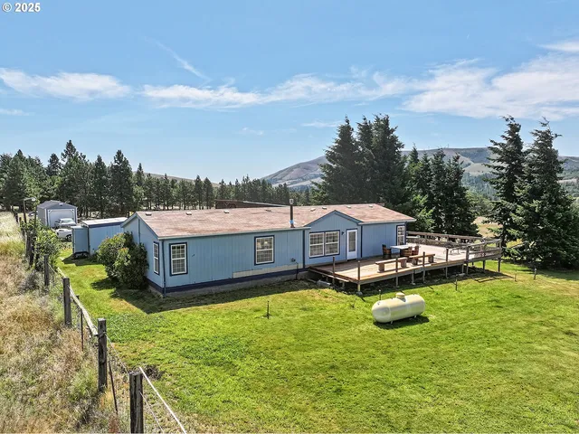 a view of a house with swimming pool and sitting area