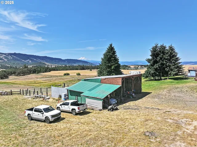 a view of a house with a garden and sitting area