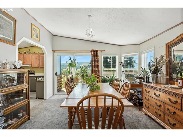 a view of a dining room with furniture window and outside view