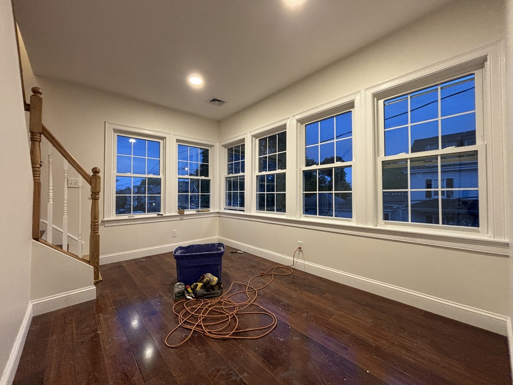 a view of a living room with furniture and wooden floor