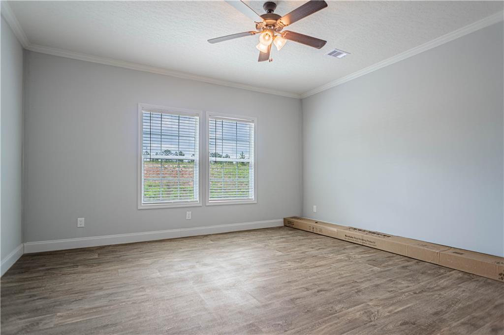 210 Ridge Road Seale, AL 36875 - Photo 8 of 16 Wood-finish flooring with crown molding and dual windows