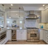a kitchen with a stove top oven sink and cabinets