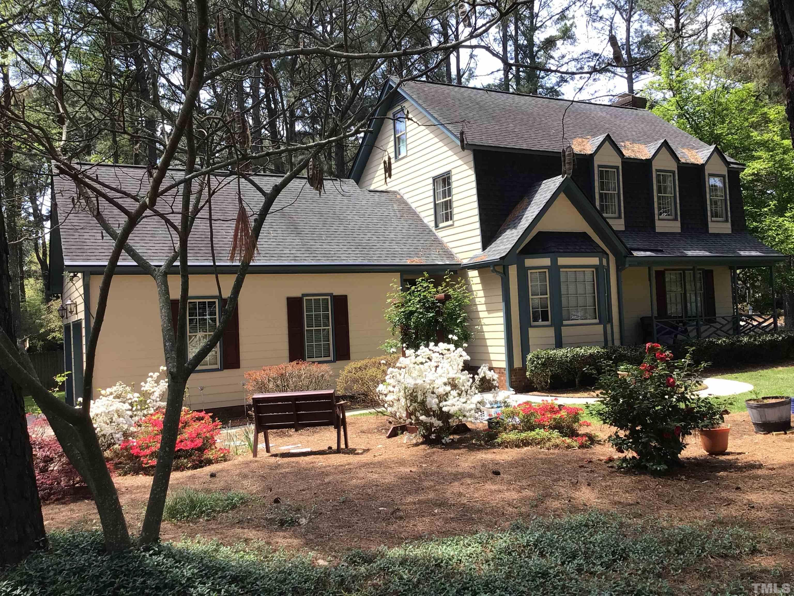a view of a house with a yard and sitting area