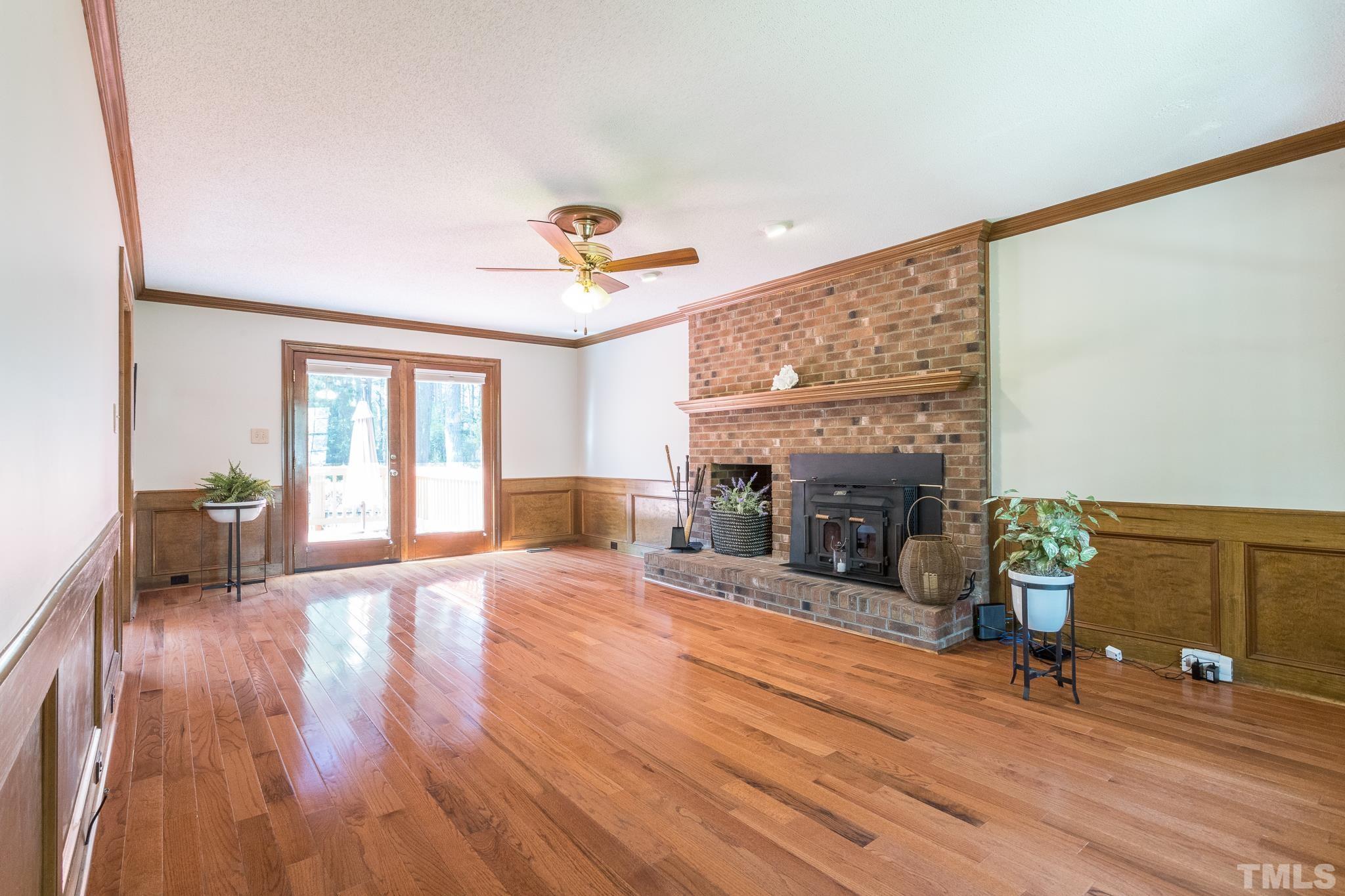 2700 Farnborough Road Raleigh, NC 27613 - Photo 11 of 36 a view of a livingroom with fireplace and wooden floor