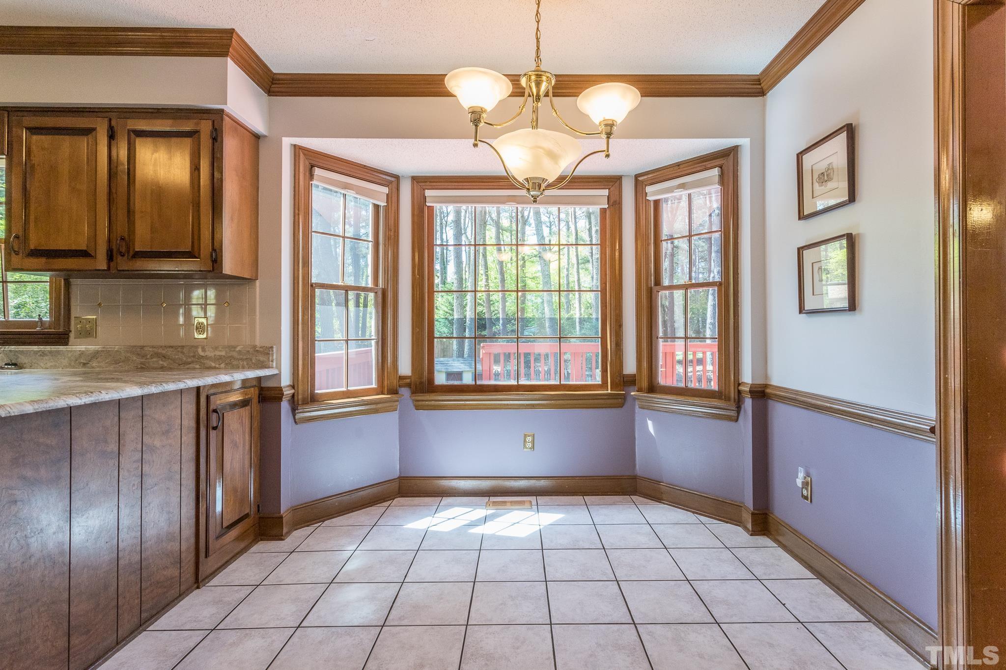 2700 Farnborough Road Raleigh, NC 27613 - Photo 15 of 36 a large kitchen with granite countertop a refrigerator and a stove top oven