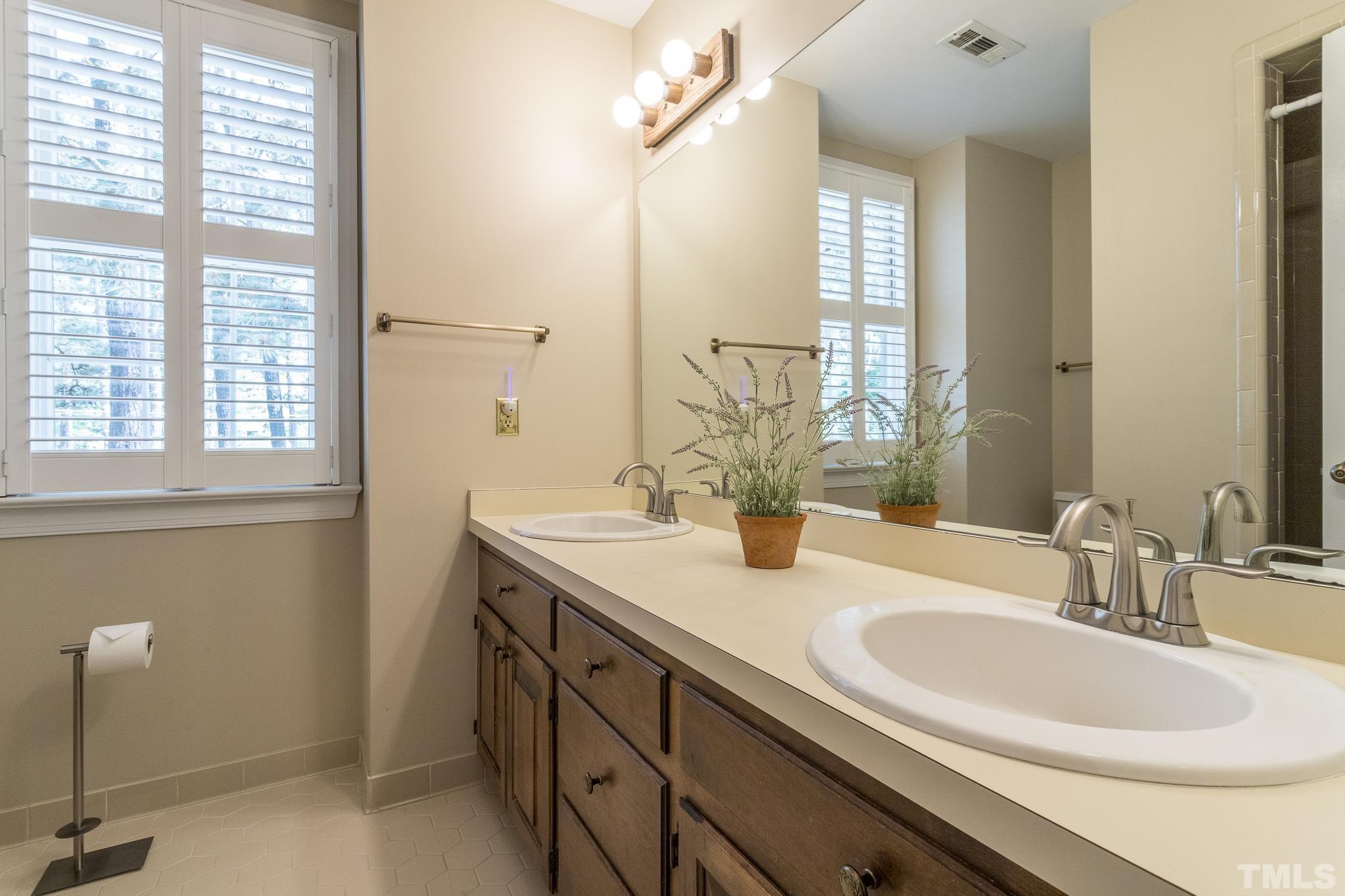 2700 Farnborough Road Raleigh, NC 27613 - Photo 25 of 36 a bathroom with a sink and a mirror
