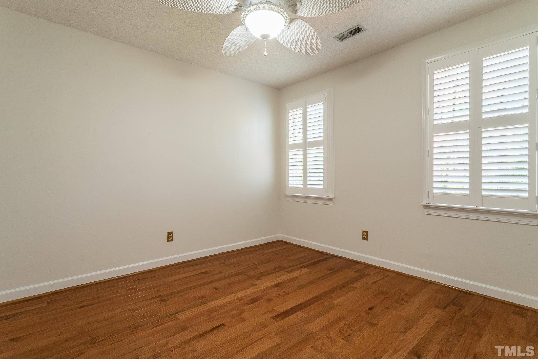 2700 Farnborough Road Raleigh, NC 27613 - Photo 28 of 36 an empty room with wooden floor and windows