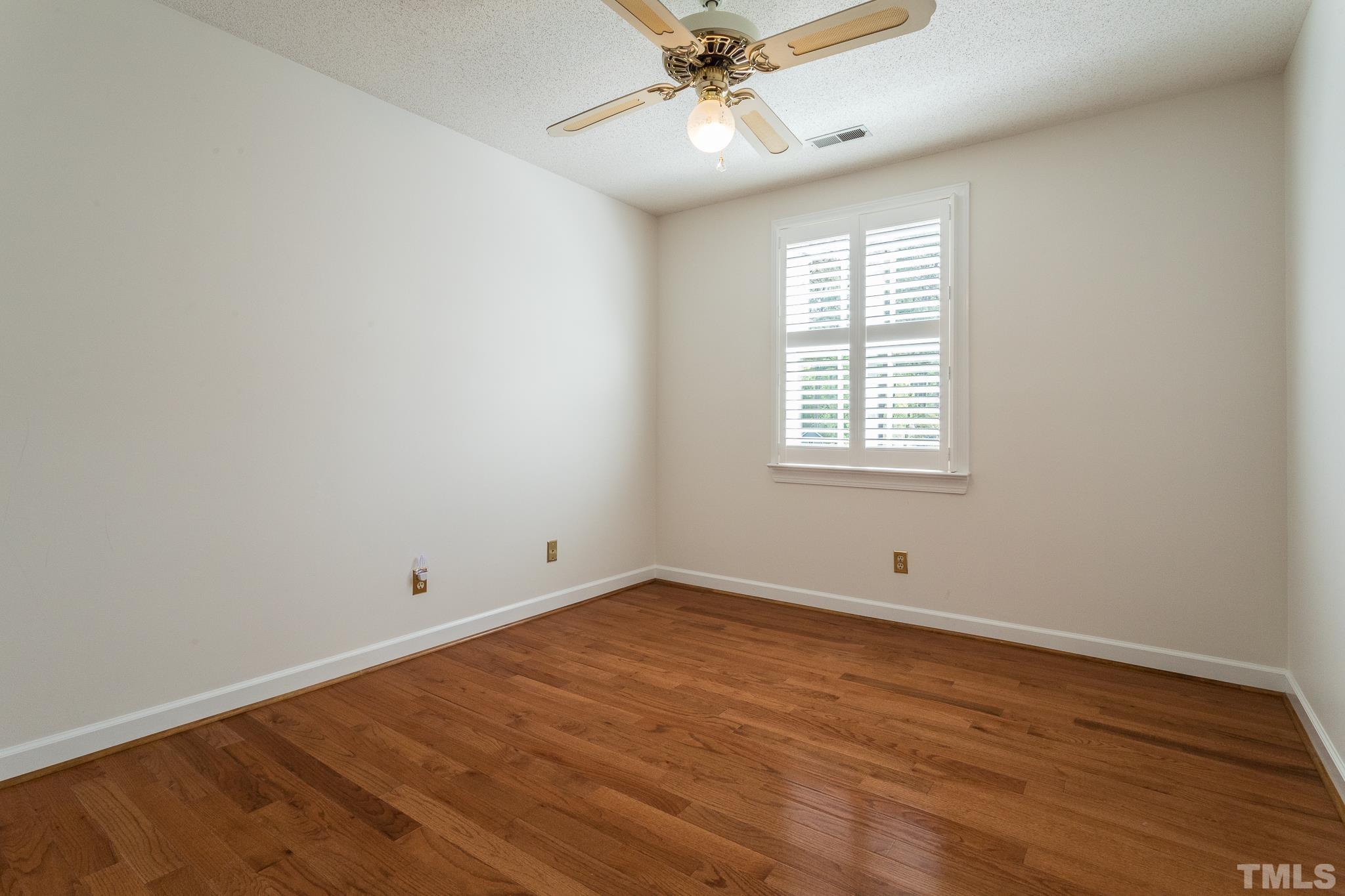 2700 Farnborough Road Raleigh, NC 27613 - Photo 29 of 36 an empty room with wooden floor fan and windows