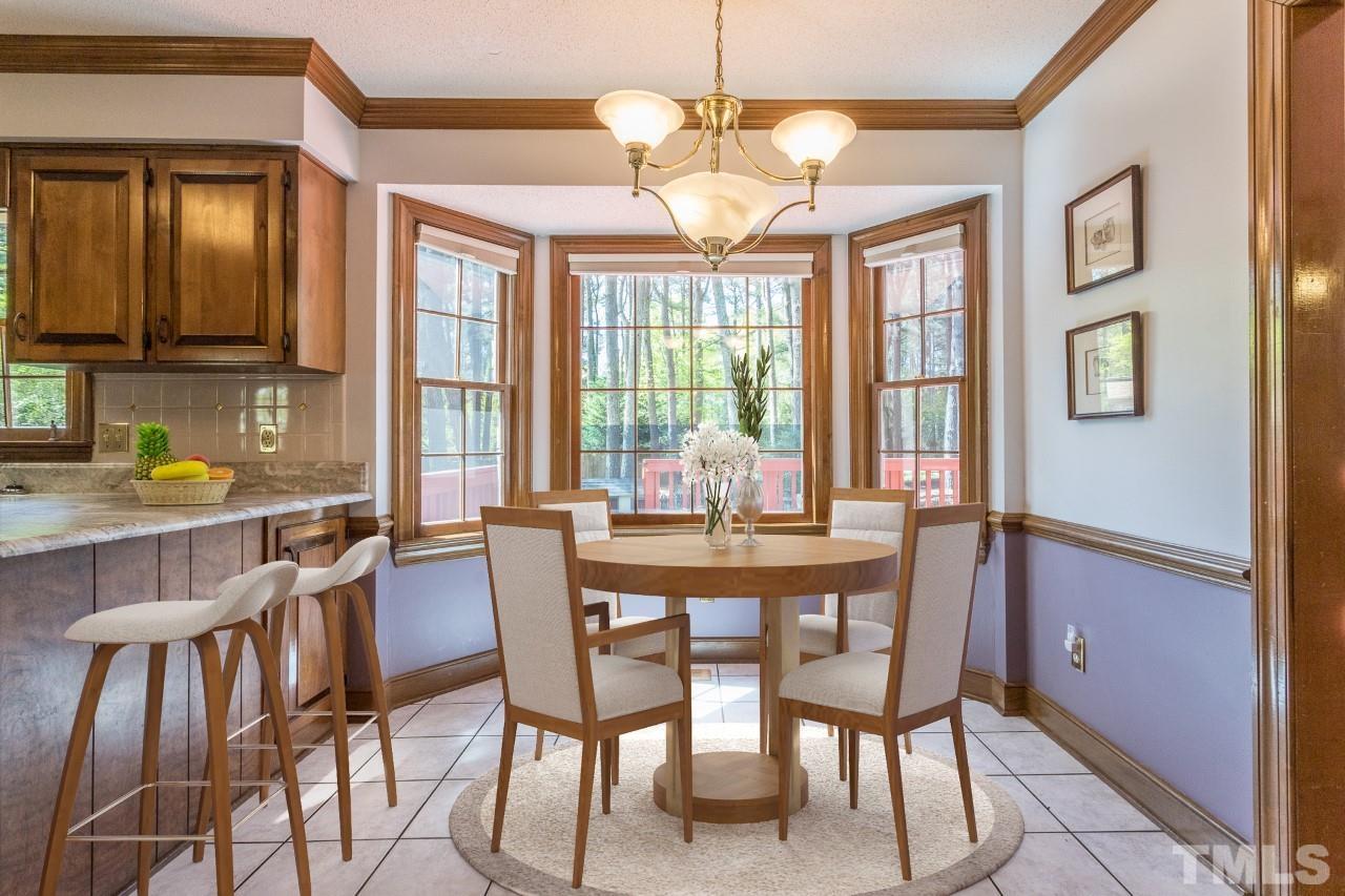 2700 Farnborough Road Raleigh, NC 27613 - Photo 33 of 36 a dining room with furniture a chandelier and window