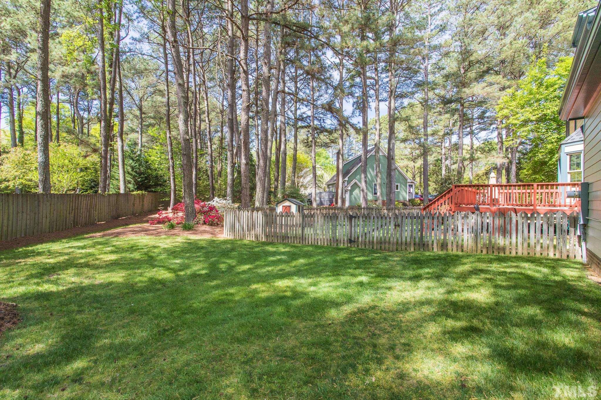 2700 Farnborough Road Raleigh, NC 27613 - Photo 5 of 36 a view of a backyard with a tree