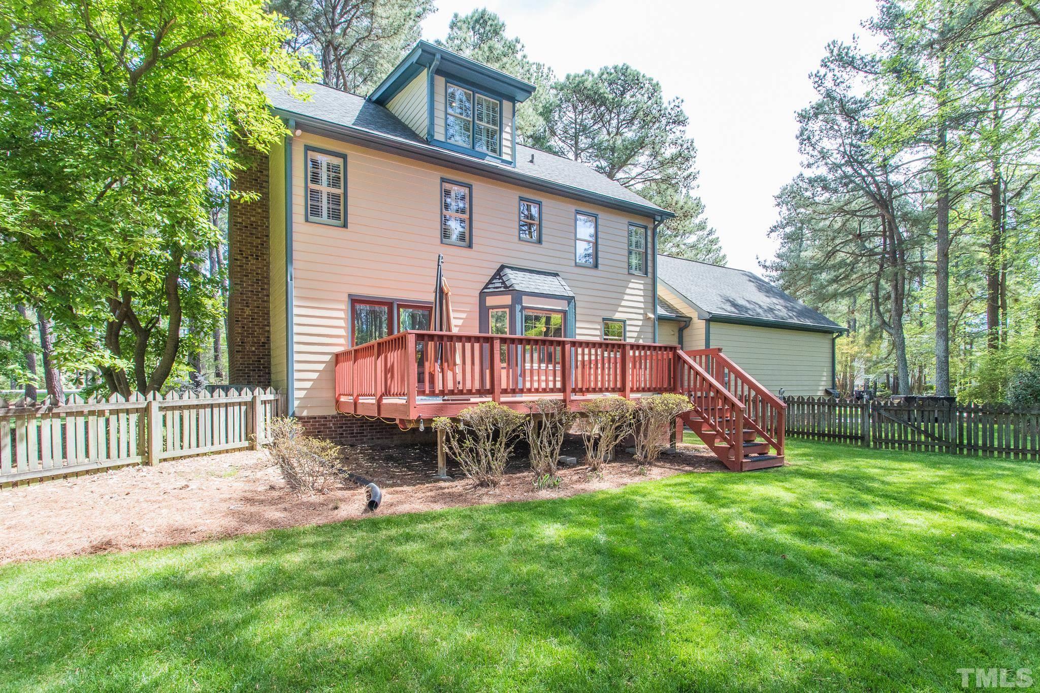 2700 Farnborough Road Raleigh, NC 27613 - Photo 8 of 36 a view of a house with a yard and a wooden deck