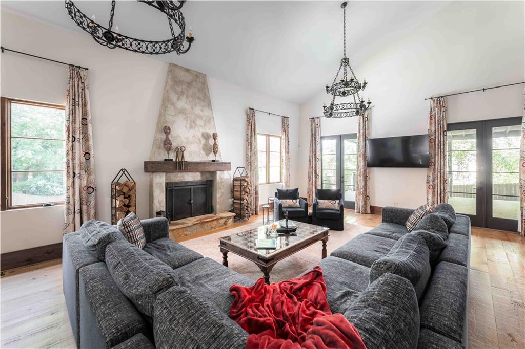 3118 West Roxboro Road Northeast Atlanta, GA 30324 - Photo 16 of 68 a living room with furniture a fireplace and a chandelier