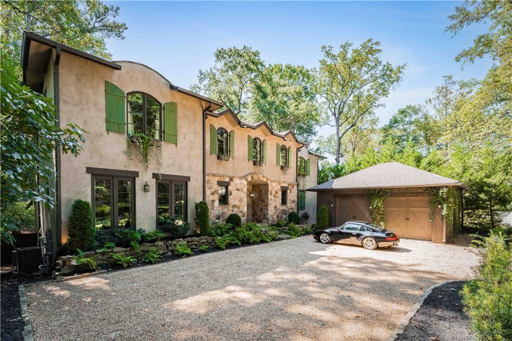 3118 West Roxboro Road Northeast Atlanta, GA 30324 - Photo 2 of 68 a view of a white house with a yard and sitting area