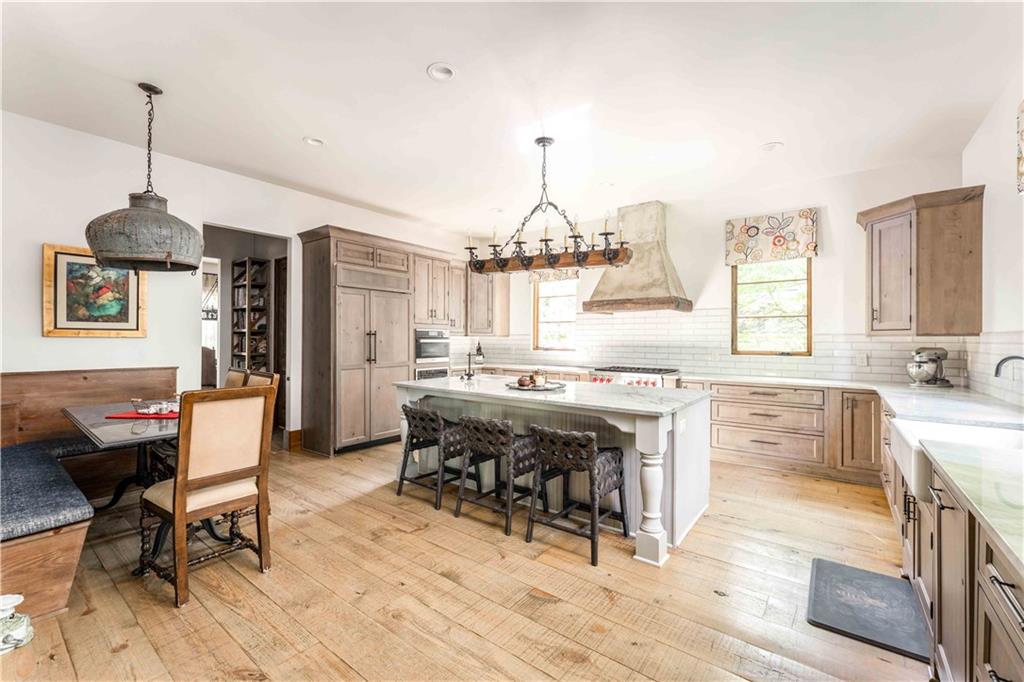 3118 West Roxboro Road Northeast Atlanta, GA 30324 - Photo 21 of 68 a dining room with chandelier and wooden floor
